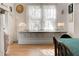 Bright dining room featuring light hardwood floors, stylish lamps and large window with sunlight streaming through at 565 Candler St, Atlanta, GA 30307