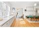 Sunlit dining area featuring stylish table and chairs leading into multiple rooms with ample living space at 565 Candler St, Atlanta, GA 30307