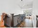 Hallway with dark wood floors, white walls, a vintage bicycle, and natural light streaming through multiple windows at 565 Candler St, Atlanta, GA 30307