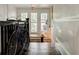 Hallway featuring hardwood floors, a black railing with a bike, a bench, bright natural light, and neutral walls at 565 Candler St, Atlanta, GA 30307