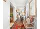 Bright and airy hallway with hardwood floors, a decorative rug, and elegant decor at 565 Candler St, Atlanta, GA 30307