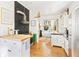 Modern kitchen featuring stainless steel appliances, painted brick wall and breakfast nook area at 565 Candler St, Atlanta, GA 30307