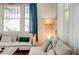 Bright living room with white sofa and decorative curtains at 565 Candler St, Atlanta, GA 30307