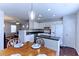 Open-concept kitchen with white cabinets, modern appliances, and seamless flow into the dining area at 5990 Mountain Top Pl, Cumming, GA 30041