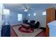 Relaxing living room featuring a comfortable sofa, ceiling fan, and abundant natural light at 5990 Mountain Top Pl, Cumming, GA 30041