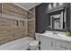 Bathroom with wood-style tile, modern vanity, tub, and showerhead at 10330 Wisteria Ln, Jonesboro, GA 30238