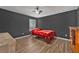 Bedroom with wood-look floors, ceiling fan, and large window at 10330 Wisteria Ln, Jonesboro, GA 30238