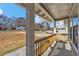 Covered front porch with wood railing overlooking the front yard and street at 10330 Wisteria Ln, Jonesboro, GA 30238