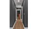 Hallway with hardwood floors and modern lighting at 10330 Wisteria Ln, Jonesboro, GA 30238