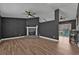 Open living room features hardwood floors, ceiling fans, and brick fireplace at 10330 Wisteria Ln, Jonesboro, GA 30238