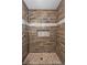 Shower with wood look tile and stone shower floor at 10330 Wisteria Ln, Jonesboro, GA 30238