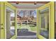 View of a backyard with a pool, outdoor seating, and a gazebo seen through yellow-framed double doors at 2007 Manassas Dr, Woodstock, GA 30189