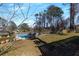 Spacious backyard with pool, patio, and mature trees at 2007 Manassas Dr, Woodstock, GA 30189