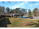 Large backyard featuring a swimming pool, patio, and mature trees at 2007 Manassas Dr, Woodstock, GA 30189