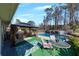 Backyard features a gazebo with seating, a dining table, a pool and established trees at 2007 Manassas Dr, Woodstock, GA 30189