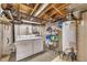 Unfinished basement with laundry area, exposed ductwork and water heater at 2007 Manassas Dr, Woodstock, GA 30189