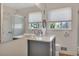 Bathroom boasts double windows over sink and vanity with a sliding glass door walk-in shower at 2007 Manassas Dr, Woodstock, GA 30189