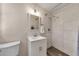 Bathroom features a vanity with a mirror and a shower with white tiles and a mosaic floor at 2007 Manassas Dr, Woodstock, GA 30189