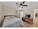 Comfortable bedroom with a ceiling fan, natural light, and a dedicated workspace for productivity at 2007 Manassas Dr, Woodstock, GA 30189