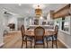Open-concept dining and kitchen area with ample seating, modern lighting, and stainless steel appliances at 2007 Manassas Dr, Woodstock, GA 30189