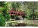 Picturesque walking bridge reflecting over the serene water surrounded by lush greenery creates peaceful scenery at 2007 Manassas Dr, Woodstock, GA 30189