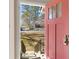 Inviting pink front door with glass panels, offering a glimpse of the well-kept exterior and lush yard at 2007 Manassas Dr, Woodstock, GA 30189