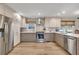 Modern kitchen featuring stainless steel appliances, light-colored cabinets, and sleek countertops at 2007 Manassas Dr, Woodstock, GA 30189