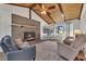 Comfortable living room with a brick fireplace, exposed wood beams, and large windows for natural light at 2007 Manassas Dr, Woodstock, GA 30189