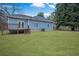 Expansive backyard featuring a well-kept lawn and a house with a wooden deck at 2820 Maxwell Pl, Lithia Springs, GA 30122
