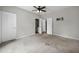 Bedroom showcasing neutral walls, carpet flooring, multiple doors, and a TV mount at 2820 Maxwell Pl, Lithia Springs, GA 30122