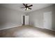 Large bedroom showcasing neutral walls, carpet flooring, and a ceiling fan at 2820 Maxwell Pl, Lithia Springs, GA 30122