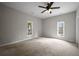 Large bedroom with two windows, neutral walls, carpet flooring, and a ceiling fan at 2820 Maxwell Pl, Lithia Springs, GA 30122