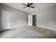 Spacious bedroom with neutral walls, ceiling fan, and multiple doors at 2820 Maxwell Pl, Lithia Springs, GA 30122