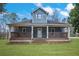 Inviting two-story home featuring a covered front porch with classic railing details at 2820 Maxwell Pl, Lithia Springs, GA 30122