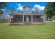 Charming blue two-story home with a welcoming front porch and manicured lawn at 2820 Maxwell Pl, Lithia Springs, GA 30122