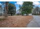 View of the home showing the driveway and a storage shed at 2820 Maxwell Pl, Lithia Springs, GA 30122