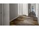 Hallway featuring modern wood-look flooring, neutral walls, and bright lighting at 2820 Maxwell Pl, Lithia Springs, GA 30122