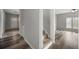 Hallway with wood flooring leads to the main entrance and carpeted stairs at 2820 Maxwell Pl, Lithia Springs, GA 30122