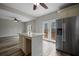 Bright kitchen with stainless steel refrigerator, island, and wood-look flooring at 2820 Maxwell Pl, Lithia Springs, GA 30122