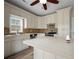 Kitchen featuring white cabinetry, backsplash, and stainless steel dishwasher and oven at 2820 Maxwell Pl, Lithia Springs, GA 30122
