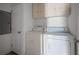 Laundry room features white washer and dryer, as well as cabinet storage at 2820 Maxwell Pl, Lithia Springs, GA 30122