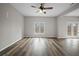 Spacious living room featuring wood floors and lots of natural light from the windows at 2820 Maxwell Pl, Lithia Springs, GA 30122