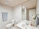 Hall bathroom with a decorative mirror and a shower with matching towels and a flower arrangement at 4805 Mystere Sw Ln, Lilburn, GA 30047