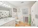 Bathroom with decorative anchor, white vanity, and framed mirror at 4805 Mystere Sw Ln, Lilburn, GA 30047