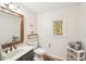Charming bathroom with decorative mirror, stained glass window, and basket storage at 4805 Mystere Sw Ln, Lilburn, GA 30047
