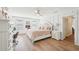 Bright bedroom features hardwood floors, white trim, and updated colors at 4805 Mystere Sw Ln, Lilburn, GA 30047