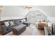 Large bonus room area with a vaulted ceiling, hardwood floors, a sofa, and a ceiling fan at 4805 Mystere Sw Ln, Lilburn, GA 30047