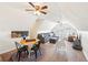 Bonus room with living room and playroom separated by a hanging chair and round colorful rug at 4805 Mystere Sw Ln, Lilburn, GA 30047
