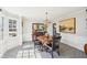 Charming dining room with a bay window, decorative chandelier, and elegant wall art at 4805 Mystere Sw Ln, Lilburn, GA 30047