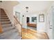 Bright entryway with hardwood floors, stairs, and access to the living room at 4805 Mystere Sw Ln, Lilburn, GA 30047